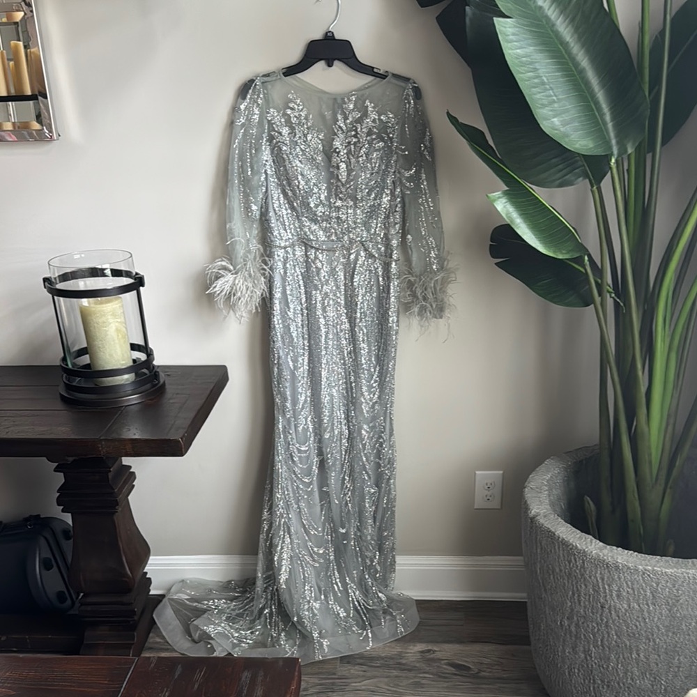 Elegant Silver Sequin Gown with Feather Details